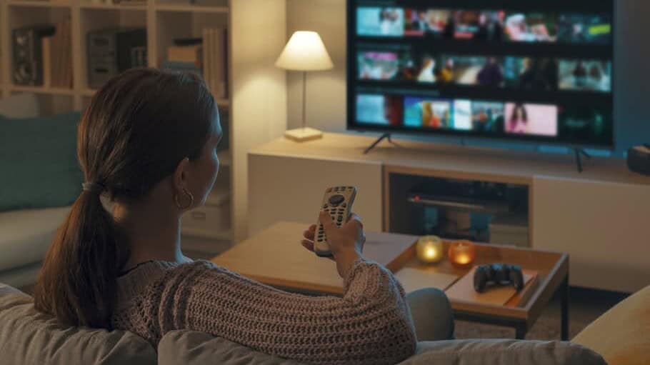 woman watches TV from the couch