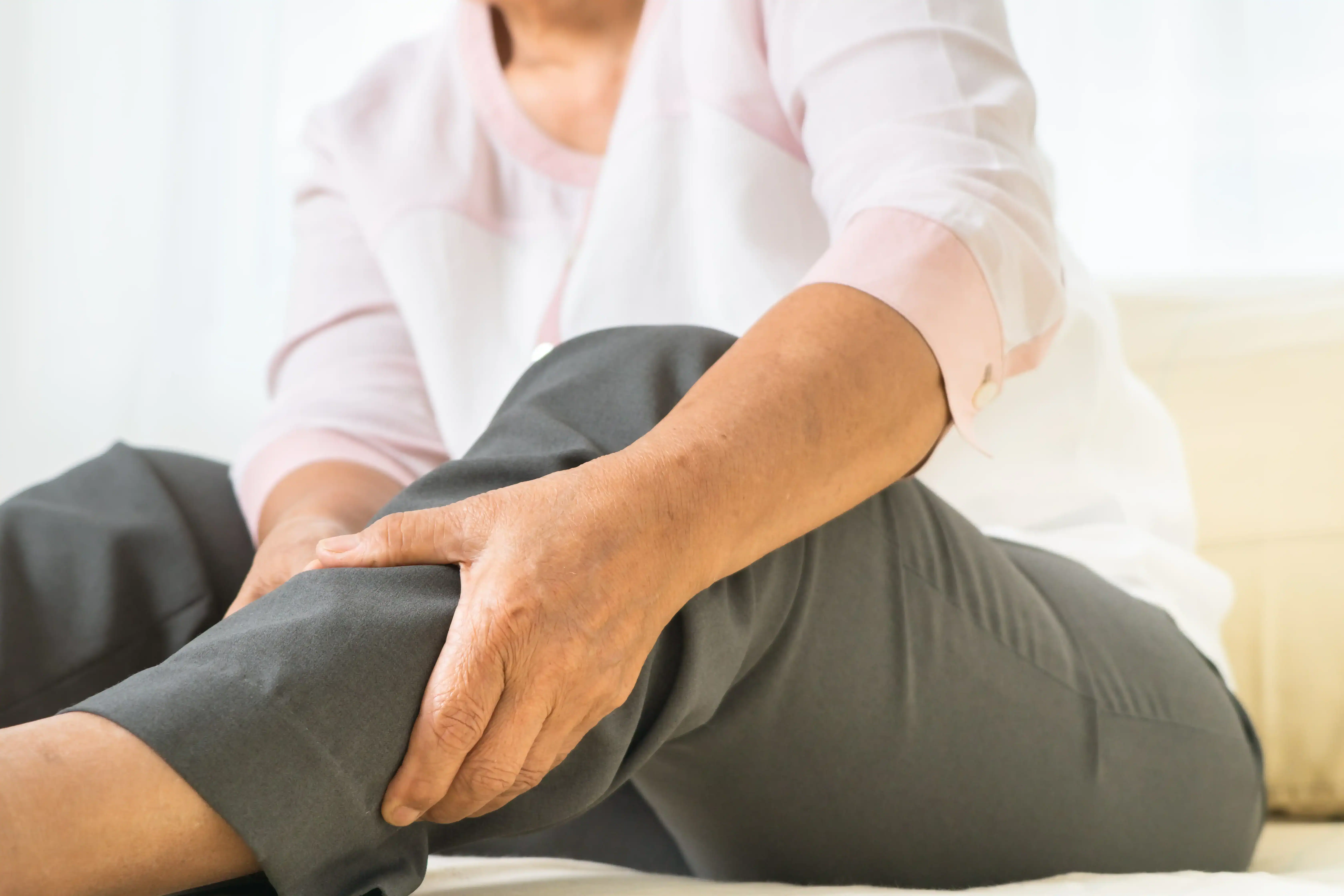 Woman grasps her calf