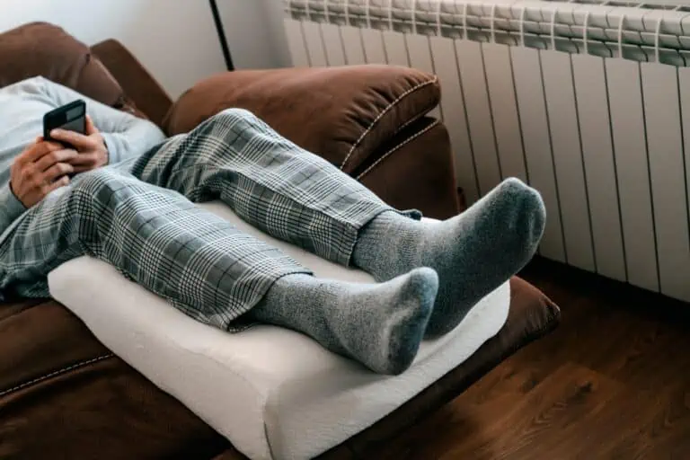 Person sitting in a recliner with feet elevated for swelling