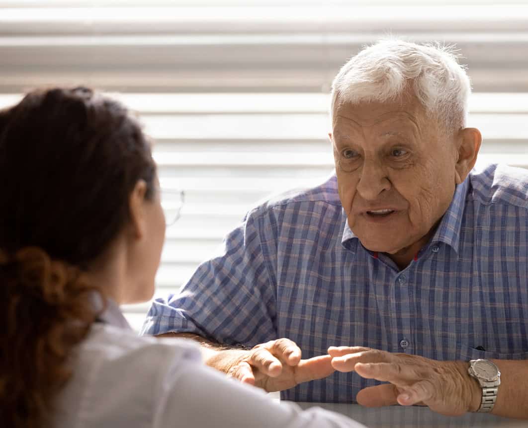 elderly man gets help at a medical office